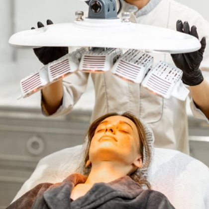 A patient receiving yellow light therapy from a skin cancer doctor